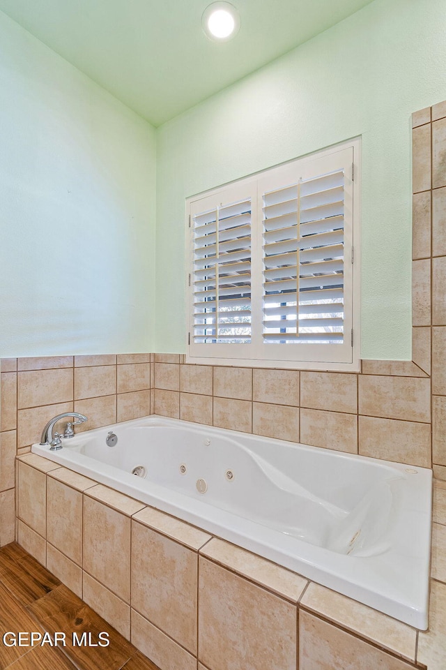 full bathroom with a whirlpool tub