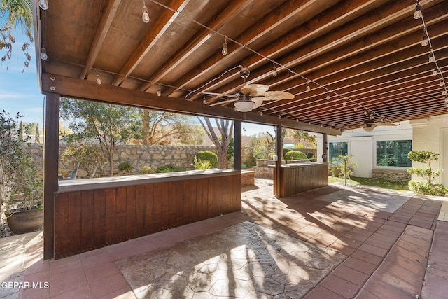 view of patio / terrace with a ceiling fan, a jacuzzi, and fence