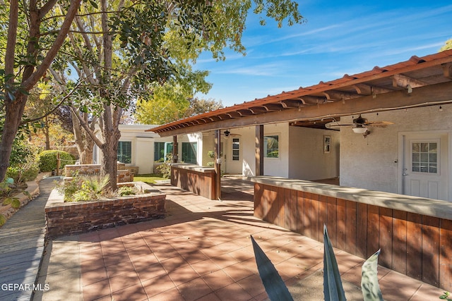 view of patio / terrace with ceiling fan and a deck