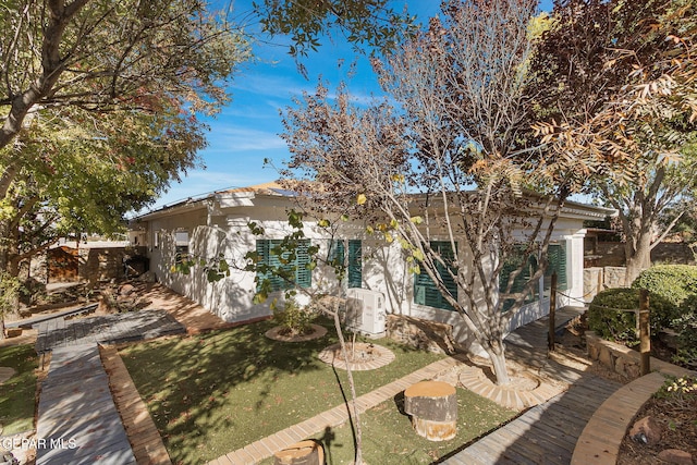 rear view of house featuring a lawn