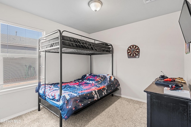 carpeted bedroom featuring baseboards