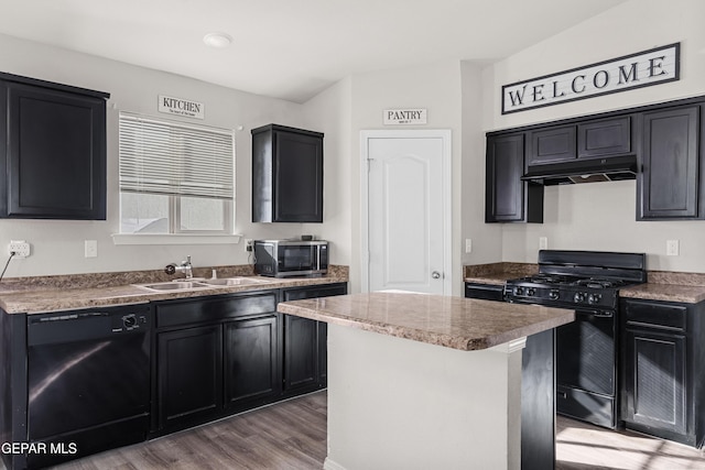 kitchen featuring light wood-style floors, a sink, dark cabinetry, under cabinet range hood, and black appliances