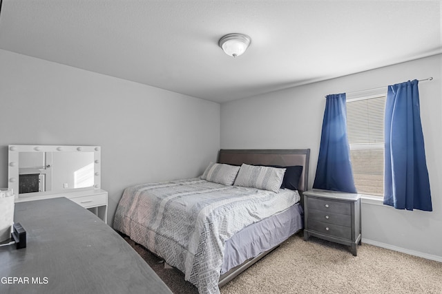 bedroom featuring baseboards, multiple windows, and light colored carpet