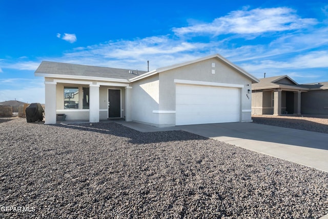 single story home with driveway, an attached garage, and stucco siding