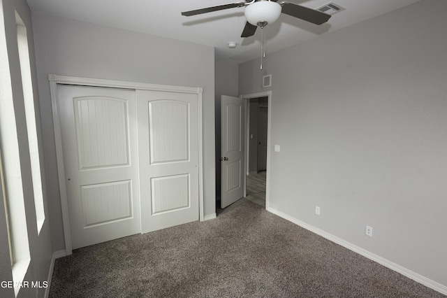 unfurnished bedroom with a closet, carpet flooring, visible vents, and baseboards