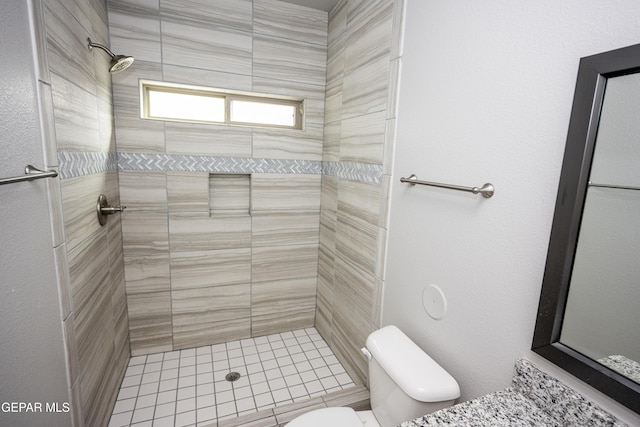 bathroom featuring toilet and tiled shower