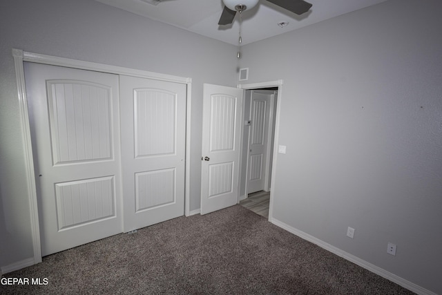 unfurnished bedroom with baseboards, visible vents, a ceiling fan, carpet flooring, and a closet