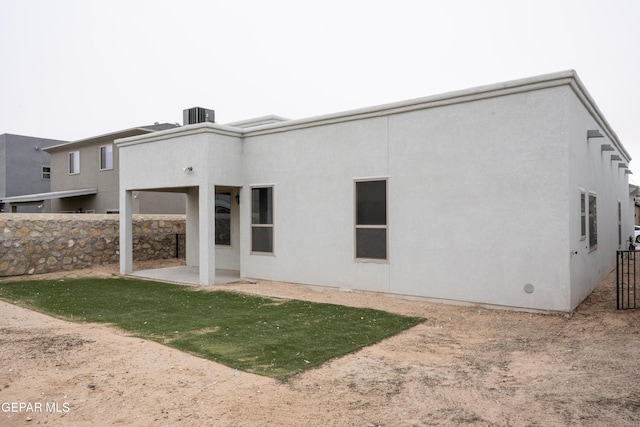 back of property featuring a patio, cooling unit, fence, and stucco siding