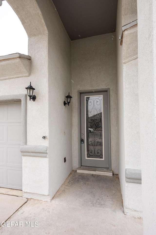 entrance to property featuring stucco siding