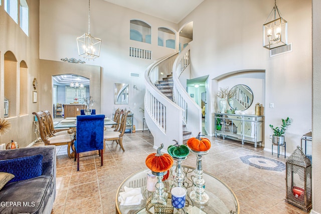 living area with a healthy amount of sunlight, stairway, a chandelier, and arched walkways