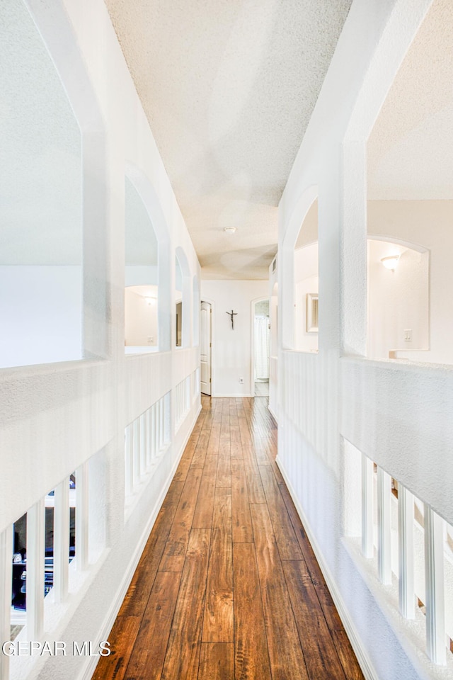 hallway featuring a textured ceiling and hardwood / wood-style floors