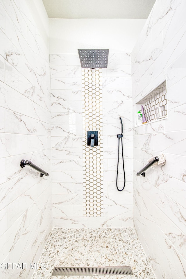 bathroom with tiled shower