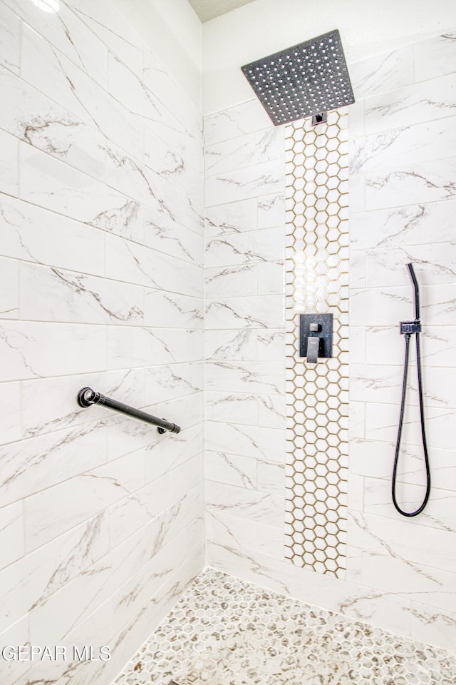 full bath featuring a tile shower