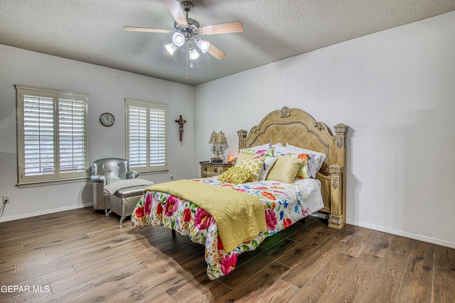 bedroom with a textured ceiling, wood finished floors, a ceiling fan, and baseboards