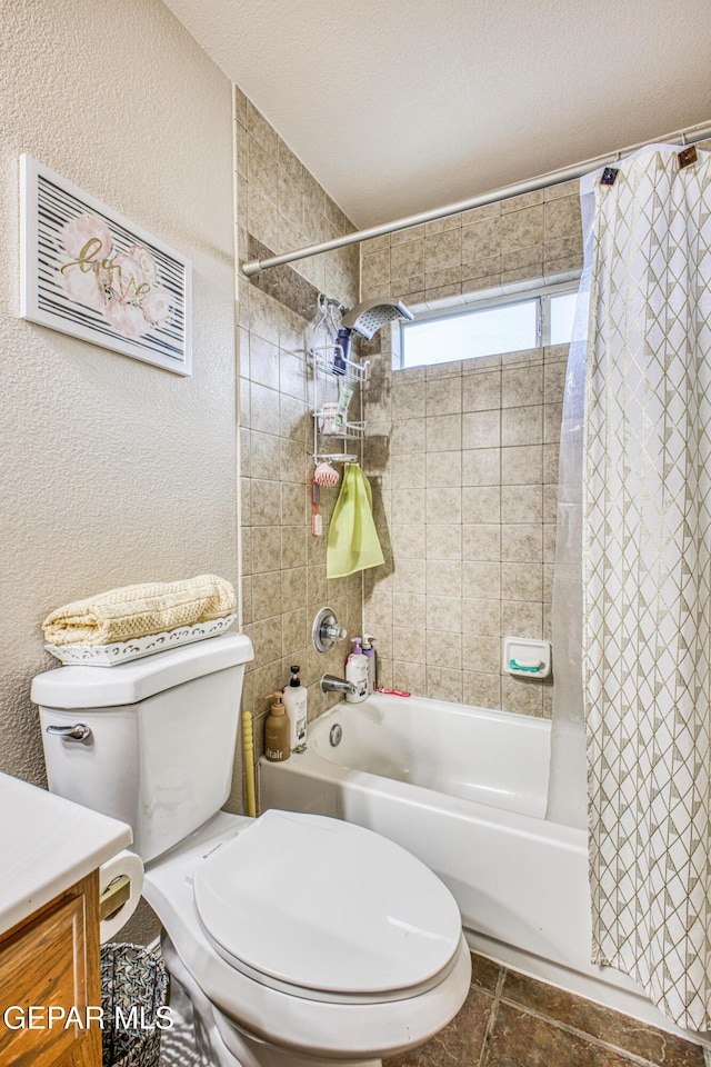 full bath featuring a textured wall, toilet, shower / bath combo with shower curtain, vanity, and a textured ceiling