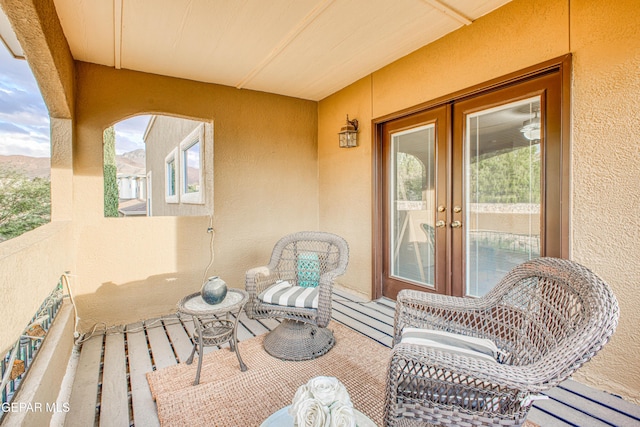 view of patio featuring french doors and a balcony