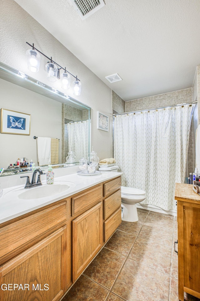 full bathroom featuring toilet, tile patterned flooring, visible vents, and a textured ceiling