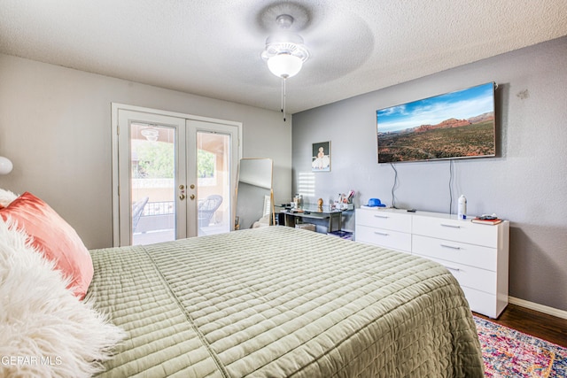 bedroom featuring baseboards, wood finished floors, access to exterior, a textured ceiling, and french doors