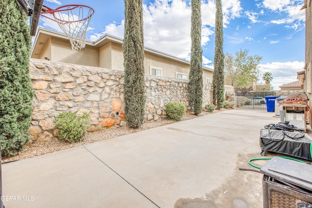 view of patio with a gate and fence