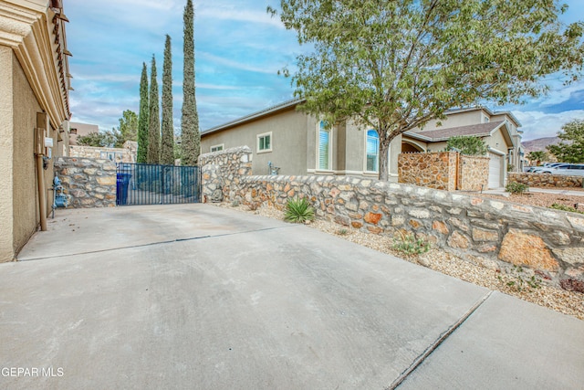 exterior space with a garage, a gate, and fence