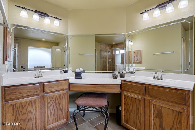 full bath with tile patterned flooring, a shower stall, and vanity