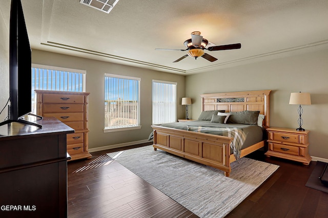 bedroom with visible vents, a ceiling fan, baseboards, and dark wood-style flooring