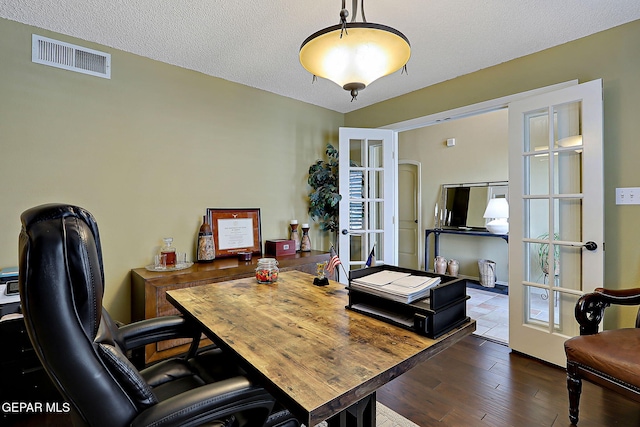 office area featuring visible vents, french doors, a textured ceiling, and wood finished floors