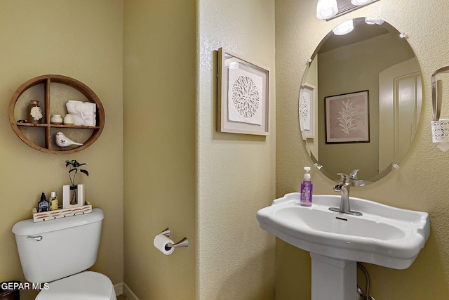 bathroom featuring toilet and a sink