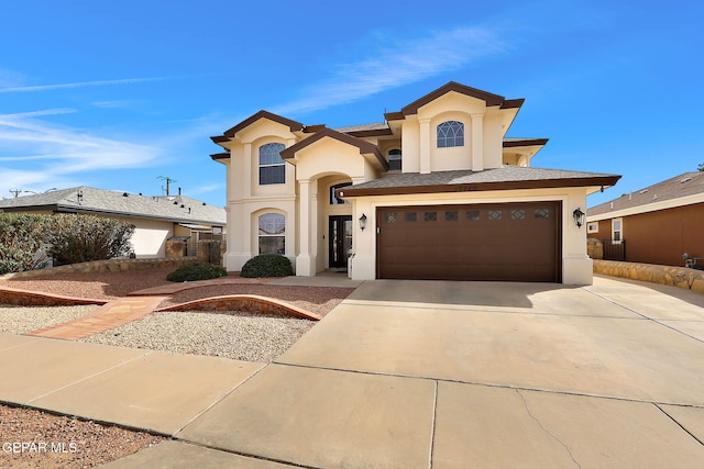 view of front of home with a garage, driveway, and stucco siding