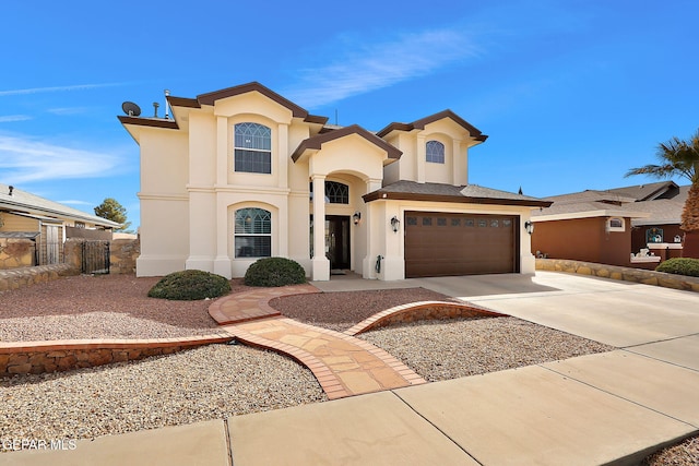 mediterranean / spanish-style house with stucco siding, a garage, concrete driveway, and fence