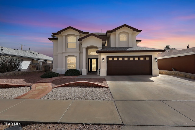 view of front of property featuring stucco siding and driveway