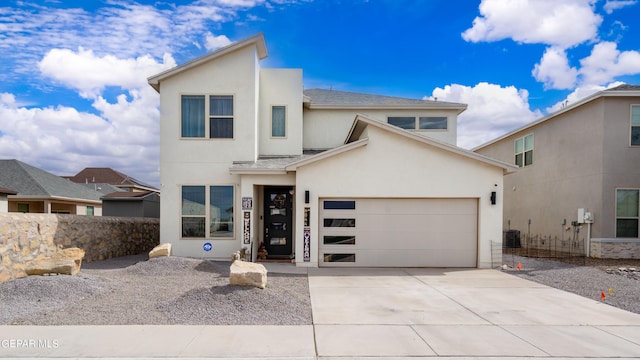 modern home with an attached garage, central AC, driveway, roof with shingles, and stucco siding