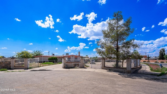 view of front of home with a fenced front yard and a gate