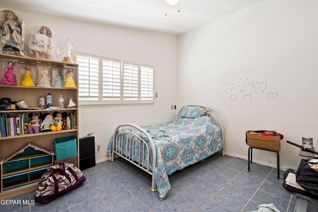 tiled bedroom featuring baseboards