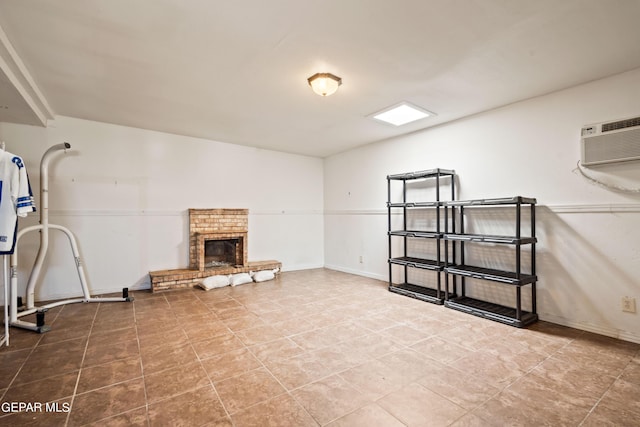 basement featuring a fireplace, baseboards, and a wall mounted air conditioner