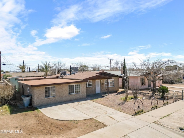 view of front of home with fence and brick siding