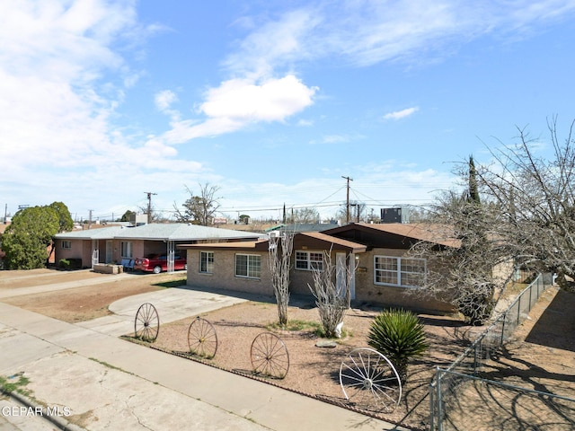 single story home featuring driveway and fence