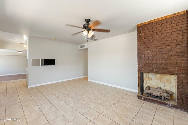 unfurnished living room featuring visible vents, a brick fireplace, baseboards, and ceiling fan