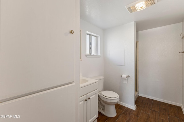 full bathroom with visible vents, toilet, wood finished floors, baseboards, and vanity