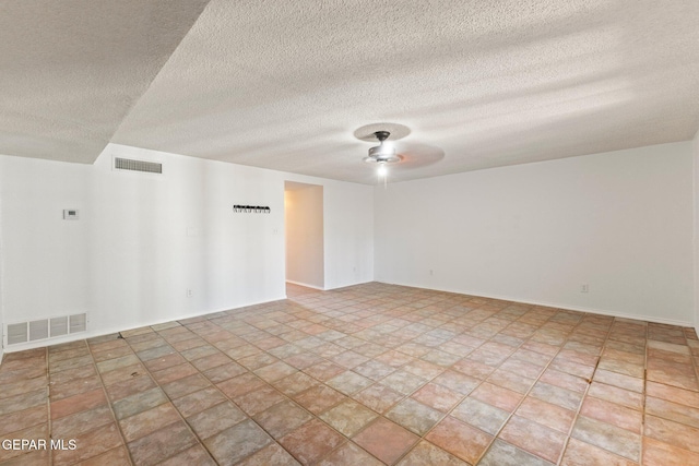 unfurnished room with baseboards, visible vents, and ceiling fan