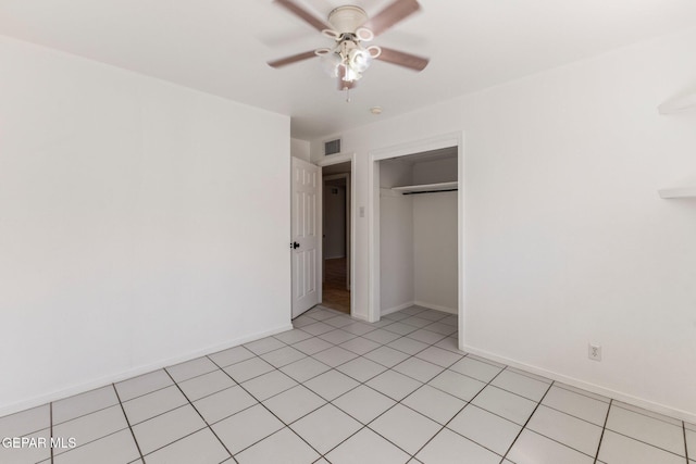 unfurnished bedroom featuring visible vents, a ceiling fan, a closet, light tile patterned floors, and baseboards