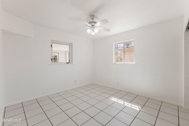 unfurnished room with light tile patterned floors, baseboards, and a ceiling fan