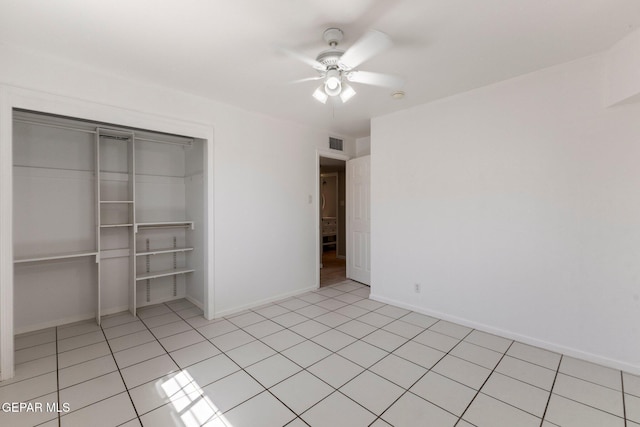 unfurnished bedroom with visible vents, a ceiling fan, a closet, light tile patterned floors, and baseboards