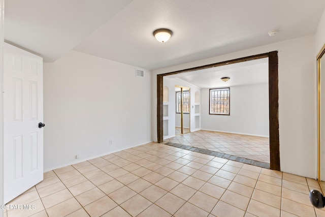 empty room featuring light tile patterned floors and visible vents