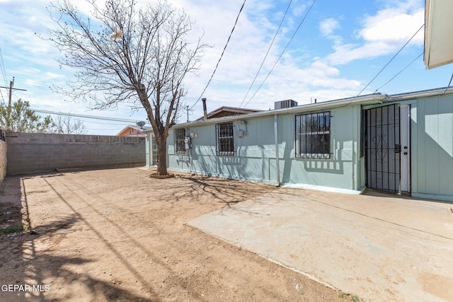 rear view of property with a patio and a fenced backyard