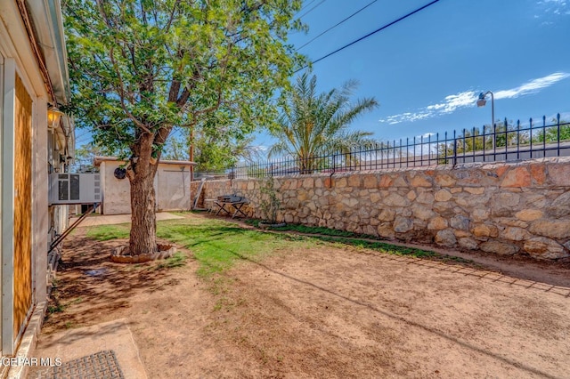 view of yard featuring an outbuilding and a fenced backyard