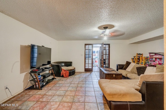 living area featuring a ceiling fan, light tile patterned floors, french doors, and a textured ceiling