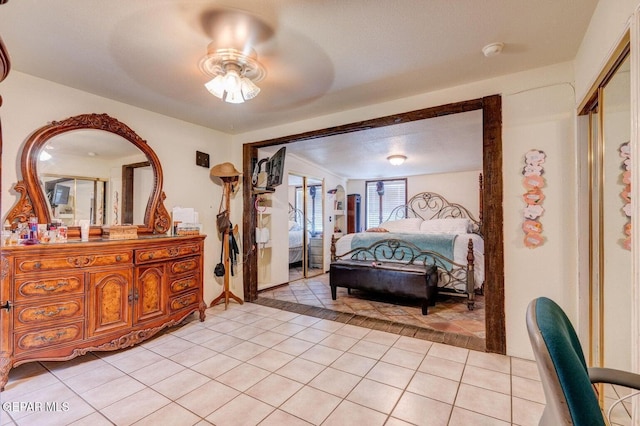 bedroom featuring light tile patterned floors and a ceiling fan