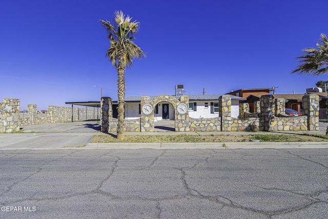 view of front of property featuring driveway and a carport