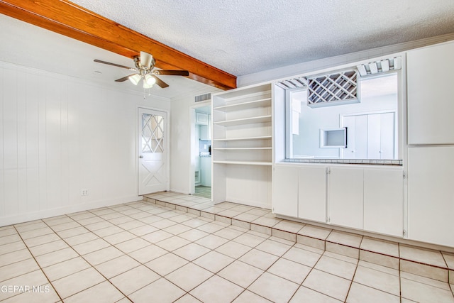 spare room with crown molding, plenty of natural light, beamed ceiling, and a textured ceiling